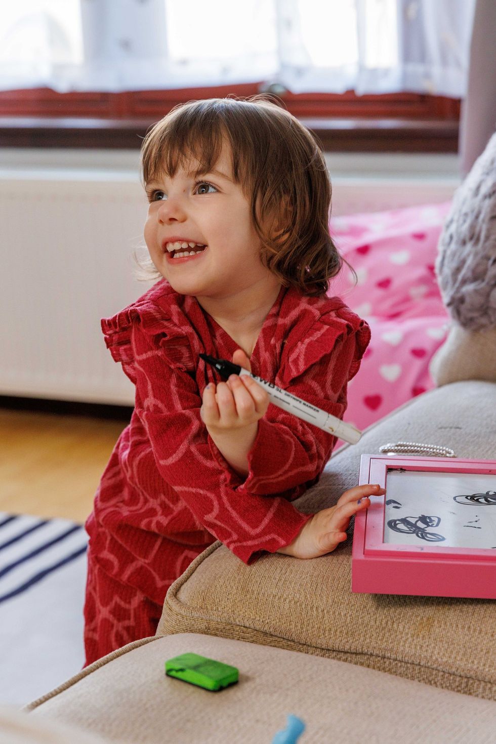 Mollie Murray, 2, pictured playing at her home, which is covered in UV resistant film to keep her safe (The Archie Foundation/Newsline Media/PA)