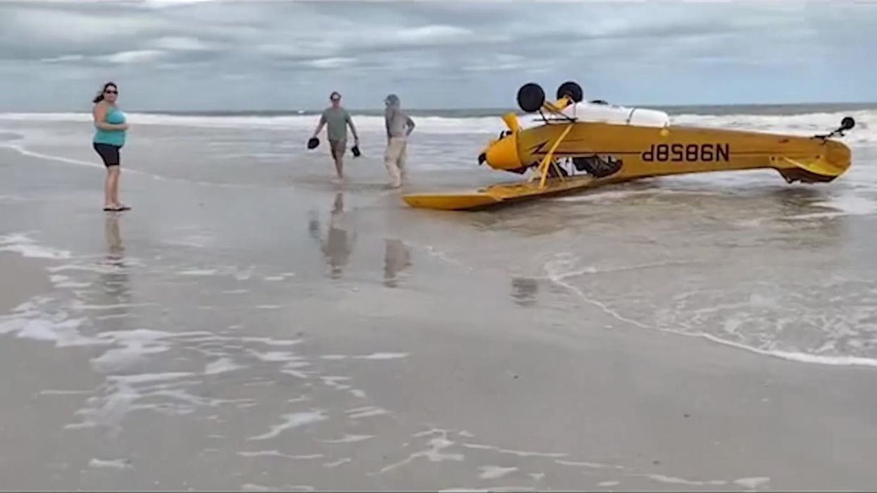 Terrifying moment plane lands upside down on a beach in Florida