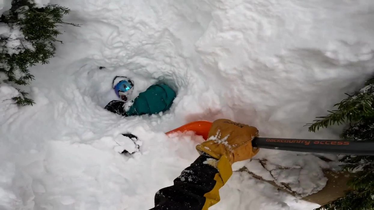 Moment hero skier spots trapped snowboarder waving from underneath mountain of snow