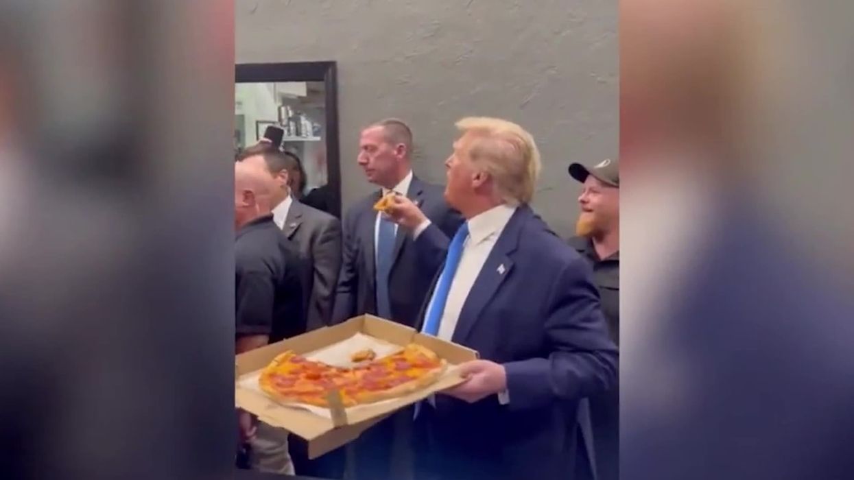 Bizarre moment Donald Trump offers restaurant goers half-eaten pizza slice