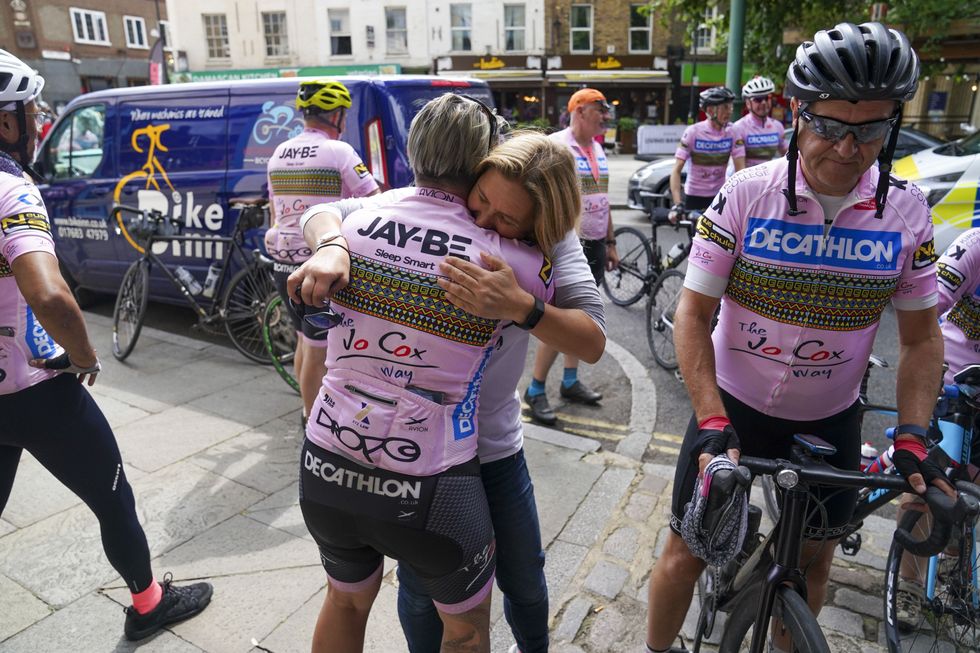 Ms Leadbeater hugs a cyclist after they arrived at the finish line (Steve Parsons/PA)