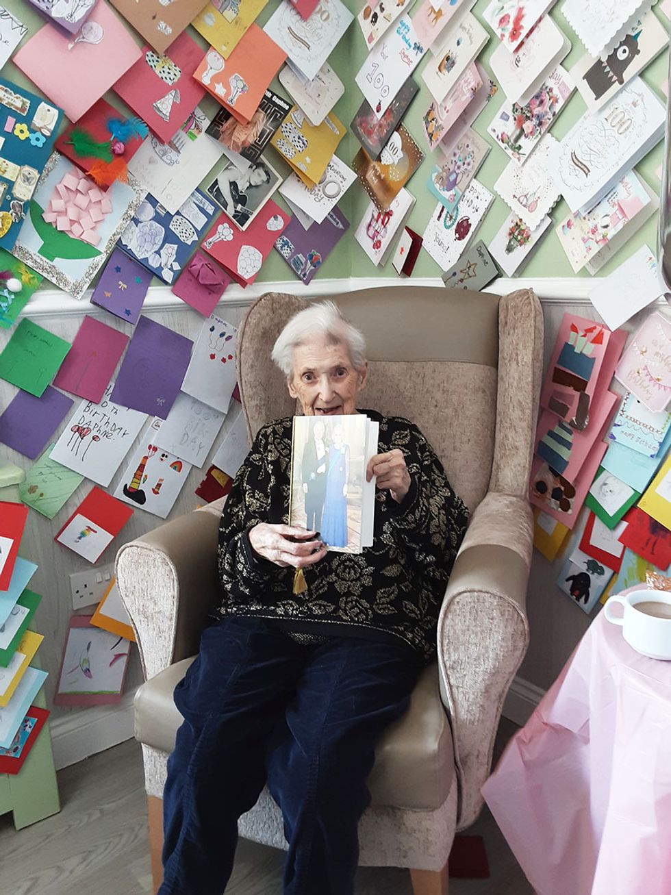 Ms XX holding her card from King Charles and Queen Camilla