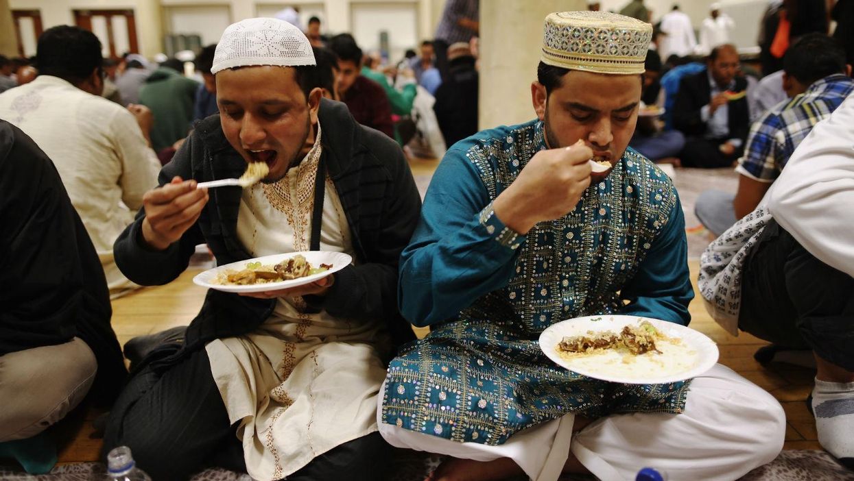 Muslim men break fast with Iftar at the East London Mosque on the last day of Ramadan in 2013