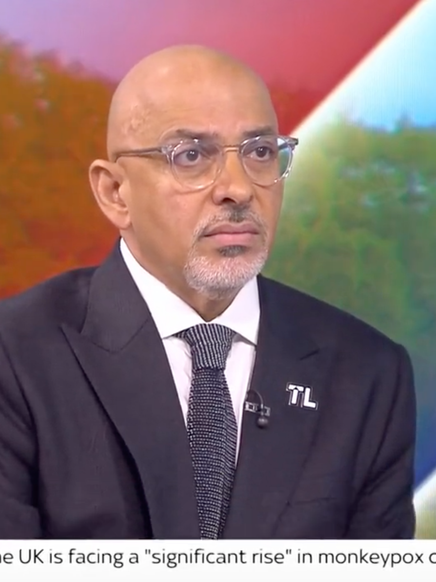 Nadhim Zahawi, a bald brown man in a black suit and glasses, sits in the Sky News studio with a neutral expression on his face.