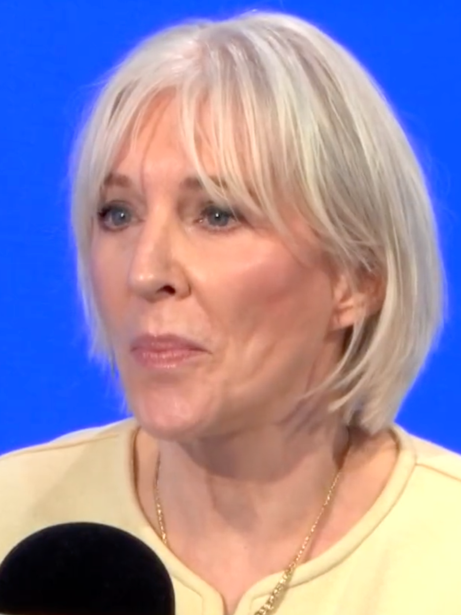 Nadine Dorries, a white woman with short blonde hair and a yellow top, speaking on LBC.