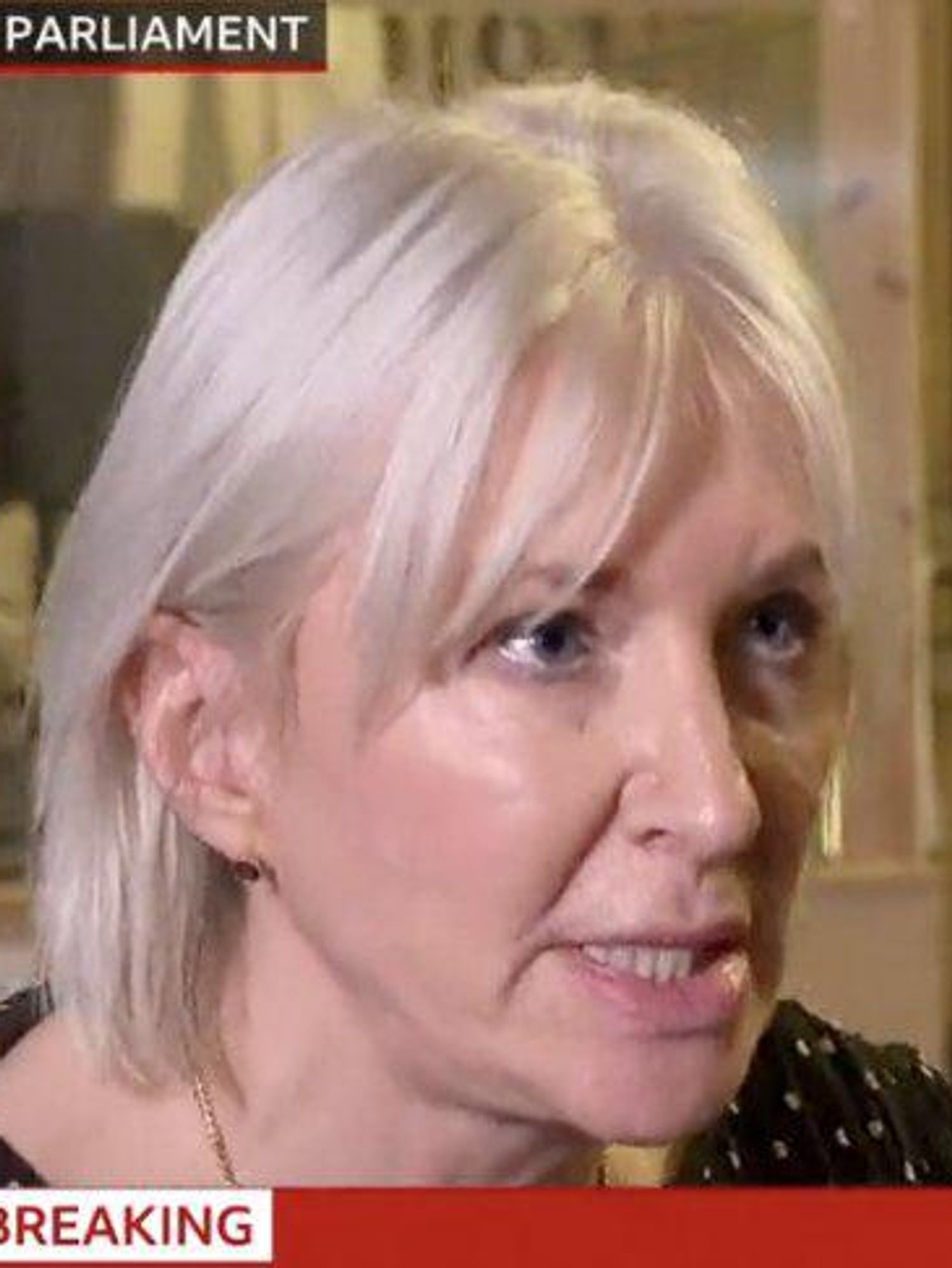 Nadine Dorries, a white woman with short blonde hair, appearing to snarl during an interview on BBC News.