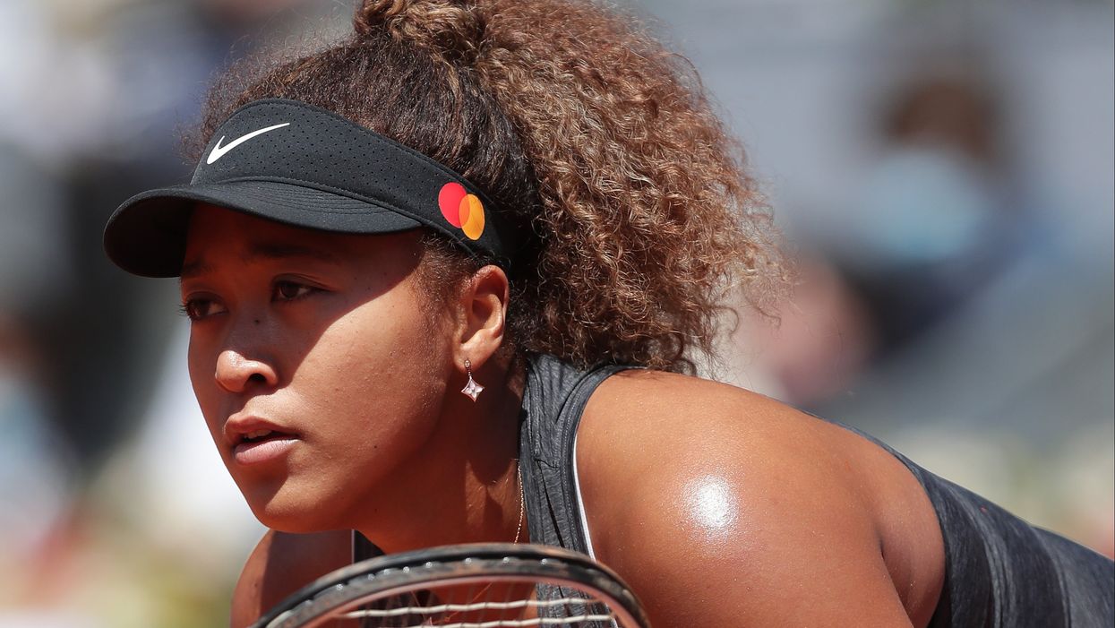 <p>Naomi Osaka of Japan waits to return serve during the second round match between Karolina Muchova of Czech and Naomi Osaka of Japan on day 4 of the Mutua Madrid Open at La Caja Magica on May 02, 2021 i</p>