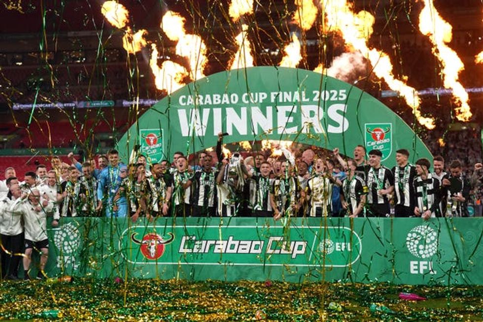 Newcastle United\u2019s Bruno Guimaraes and Kieran Trippier lift the Carabao Cup trophy