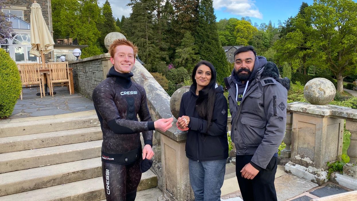 Newly-engaged couple Viki Patel and Rebecca Chaukria with Angus Hosking, the diver who retrieved their wedding ring after it went missing in Lake Windermere (Angus Hosking/PA).