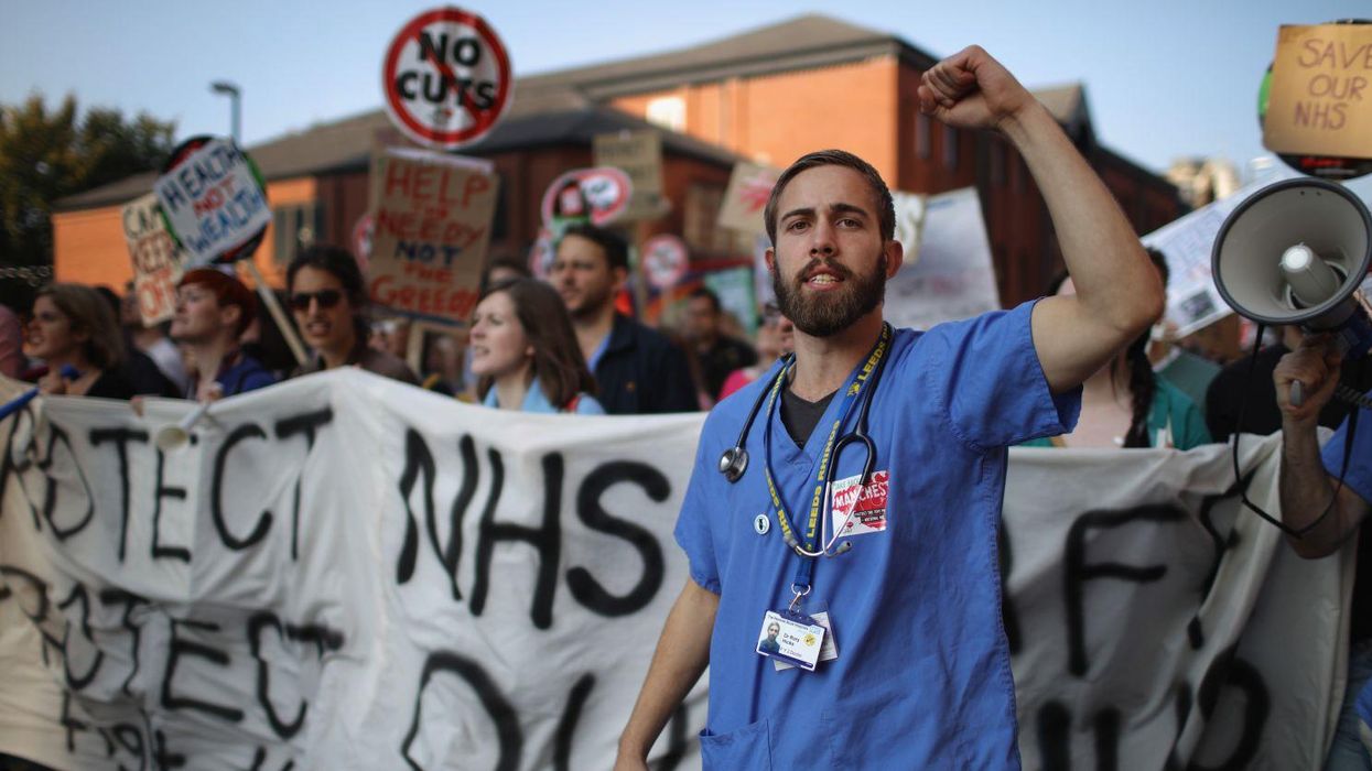 NHS workers take part in an anti-austerity protest on 4 October 2015 in Manchester