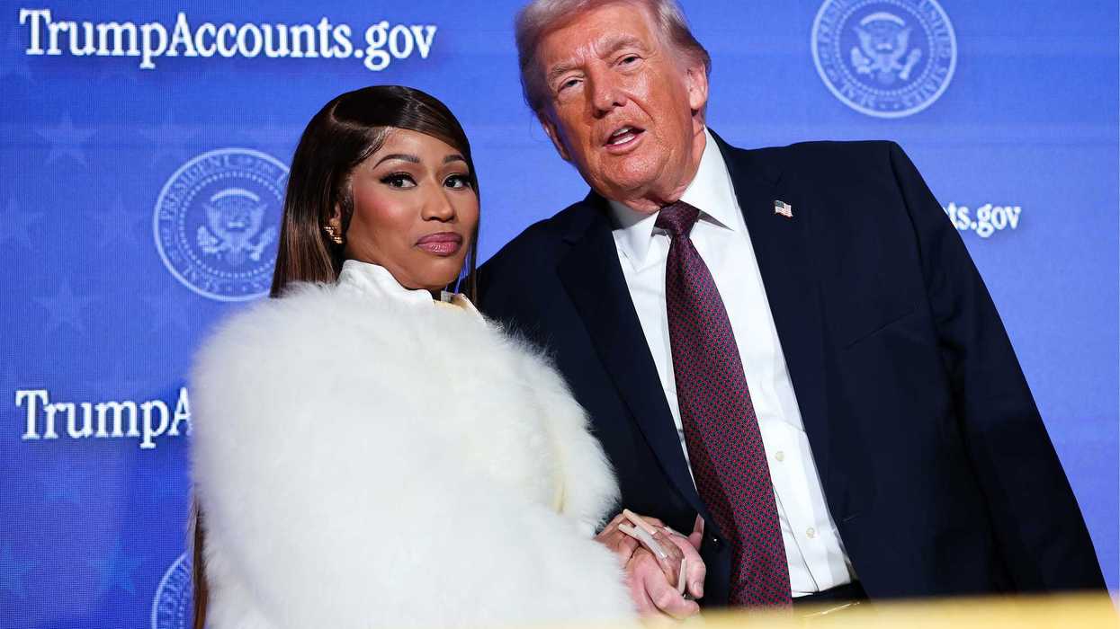 Nicki Minaj in a white fur jacket standing next to Donald Trump in a black suit with a purple tie.