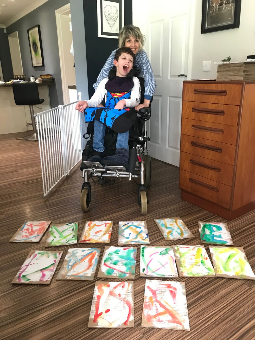 Noah and his mother Laura Jones pose with some of his backgrounds