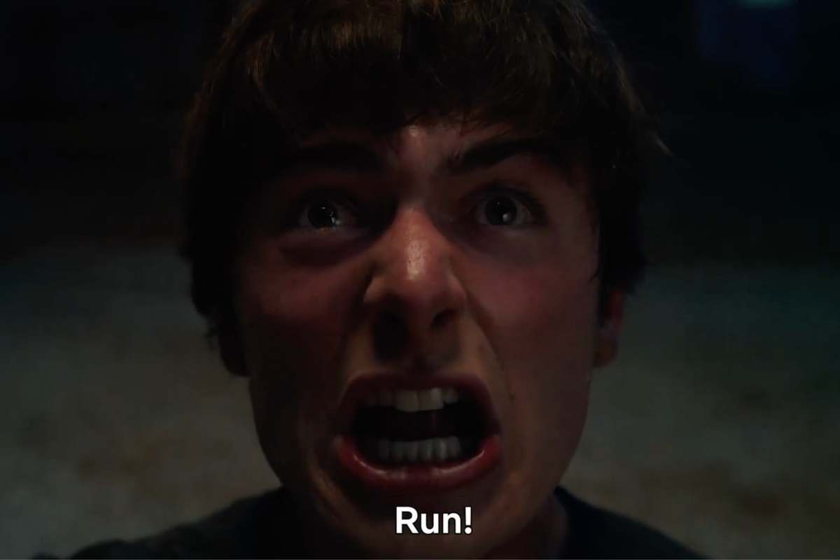 Noah Schnapp as Will Byers in Stranger Things, yelling 'run'.