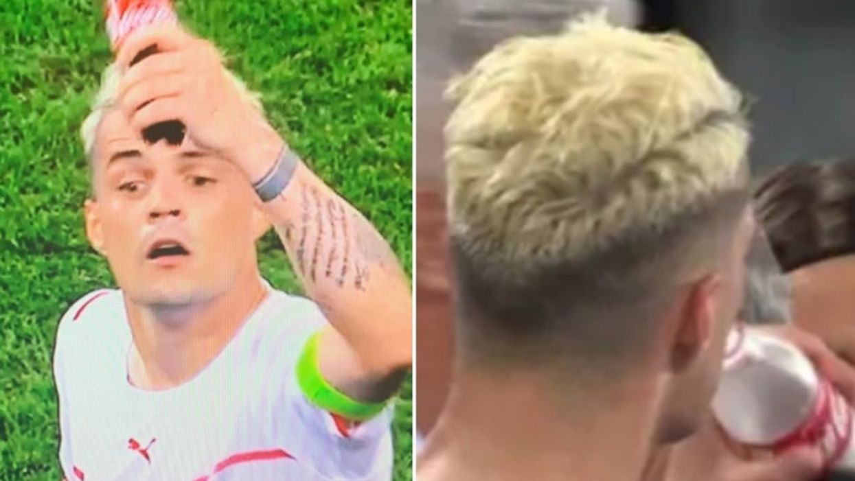 <p>Not a common sight in football - Granit Xhaka seen swigging from a bottle of Coca Cola during the France v Switzerland match</p>