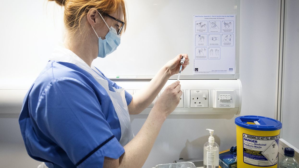 Nurse prepares Covid vaccine at NHS hospital in Glasgow