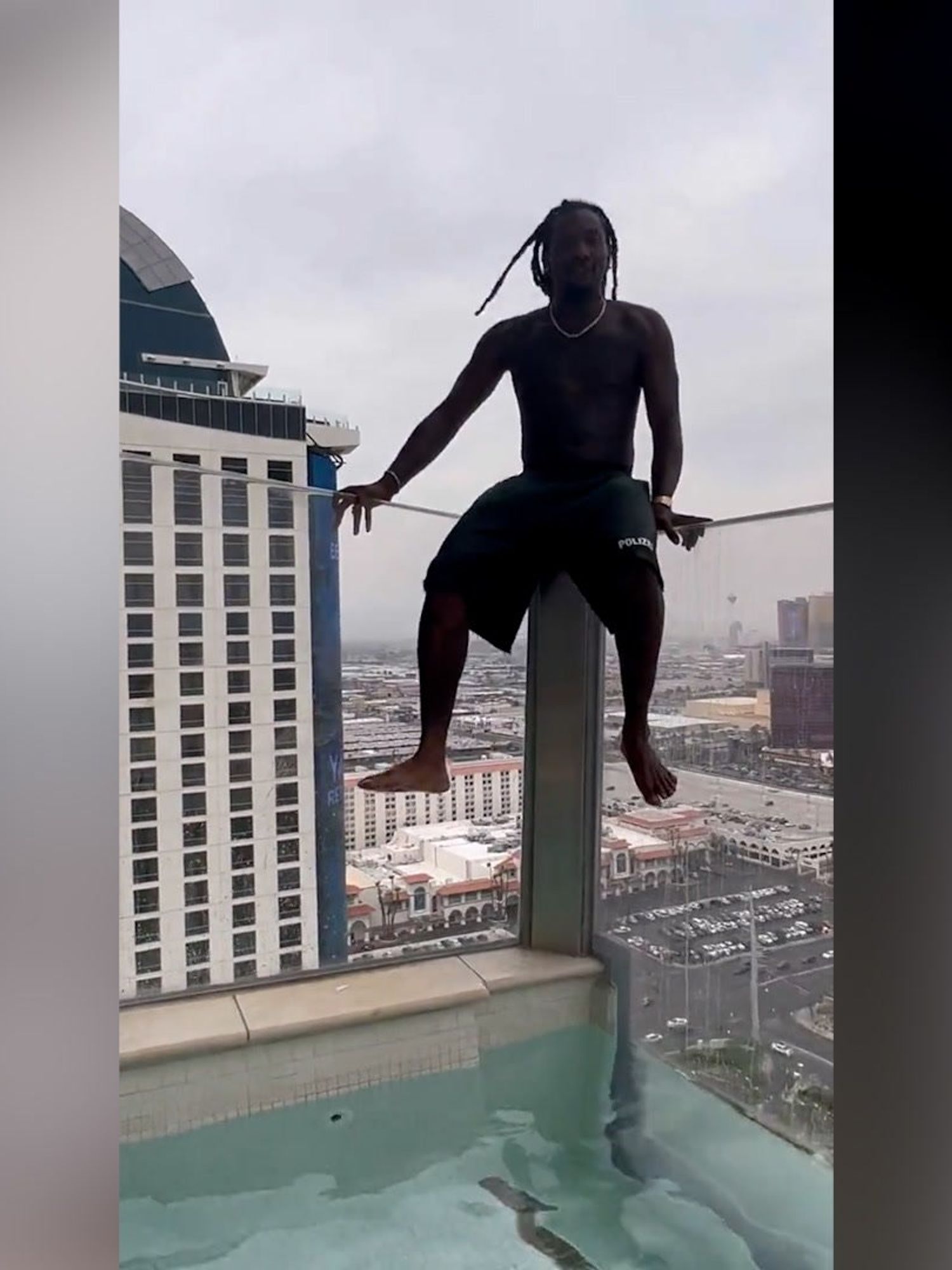 Offset casually hangs off balcony of a skyscraper