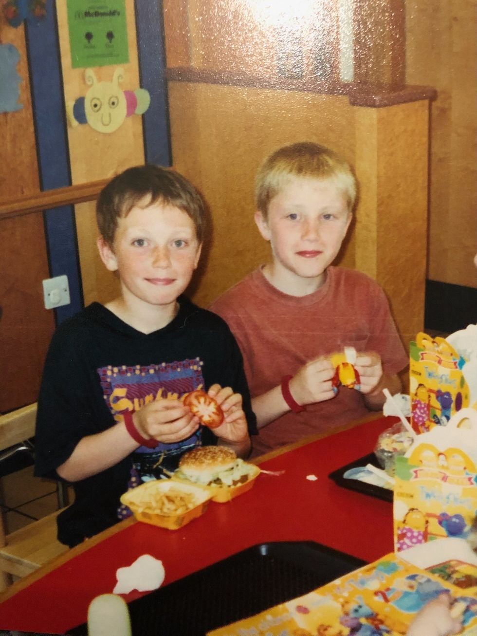 Old family photo of two boys eating lunch together