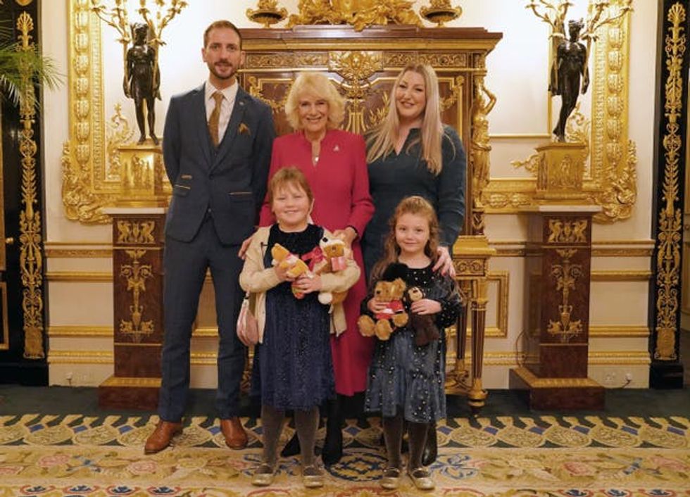 Olivia and her family posing for a picture with Camilla