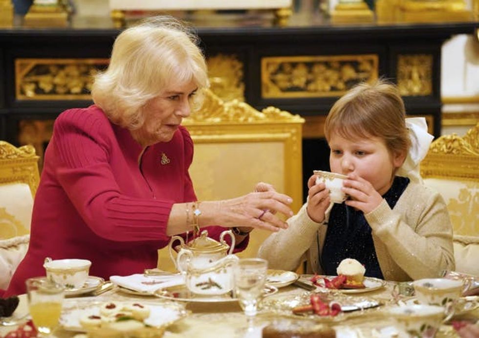 Olivia Taylor drinking tea with the Queen