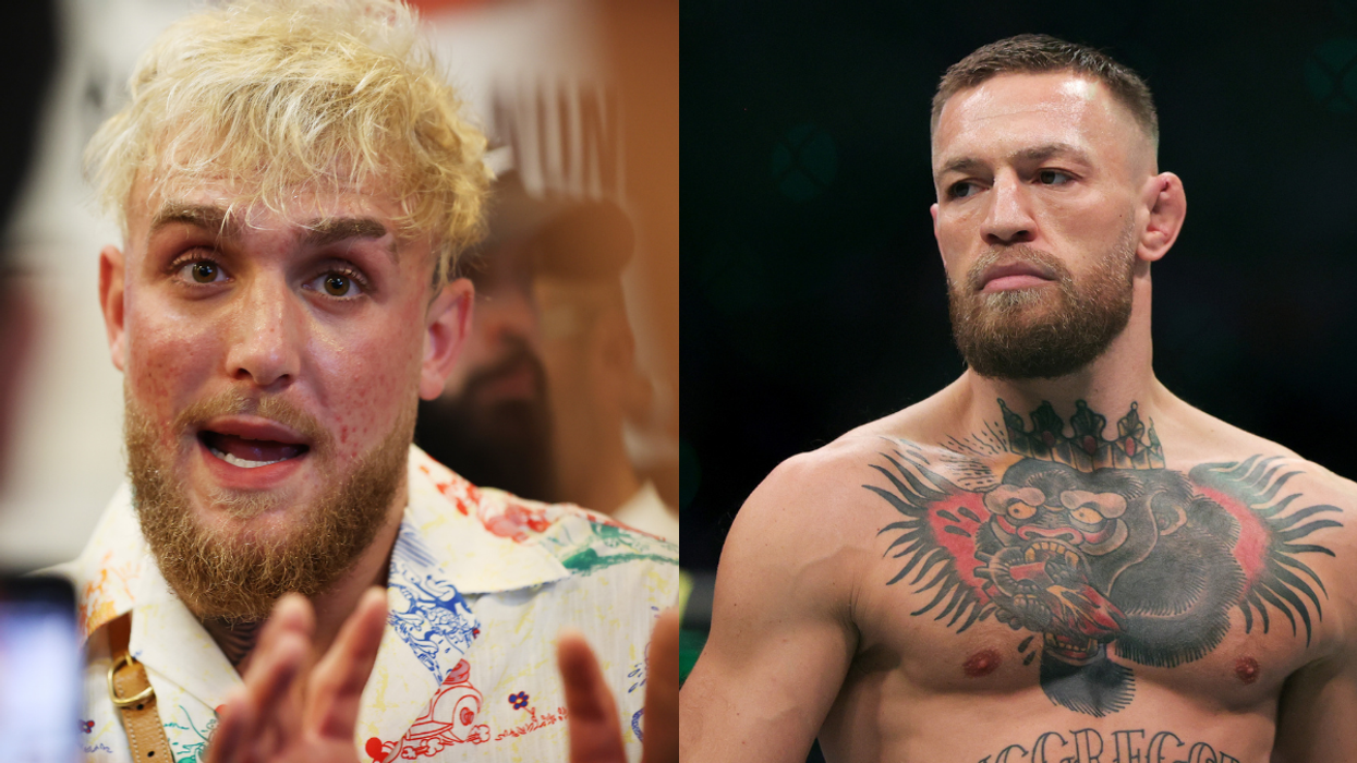 On the left, Jake Paul, a white man with messy blonde hair, and a beard, talks to someone behind the camera. On the right is Conor McGregor, a bare-chested white man.
