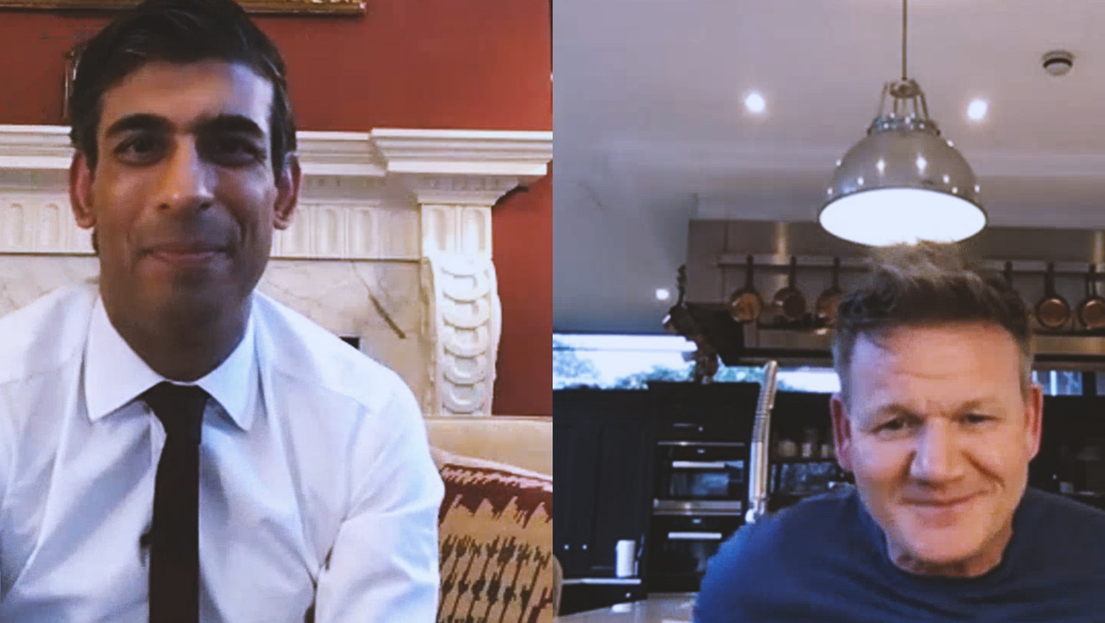 On the left, Rishi Sunak smiles at the camera in a white collared shirt and black tie. On the right, Gordon Ramsay, in a  blue shirt, is smiling. He appears to be sitting in a kitchen, with wine glasses and a metal counter behind him.