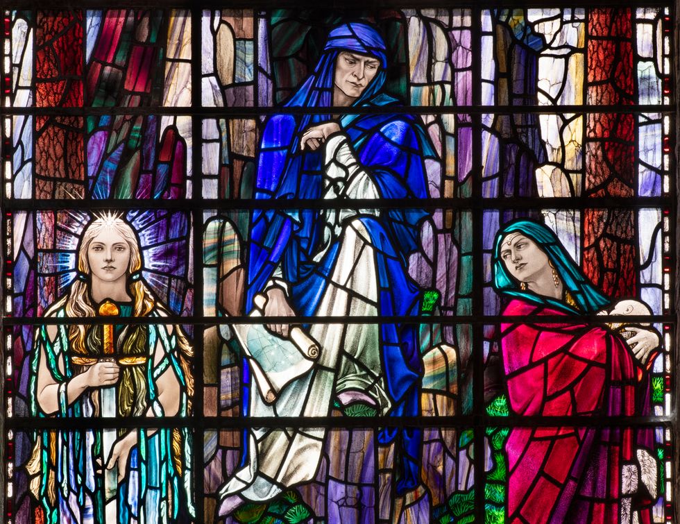 One of Veronica Whall's stained glass windows depicting Merlin and the Lady of the Lake with the infant Mordred (James O Davies/Historic England/PA)