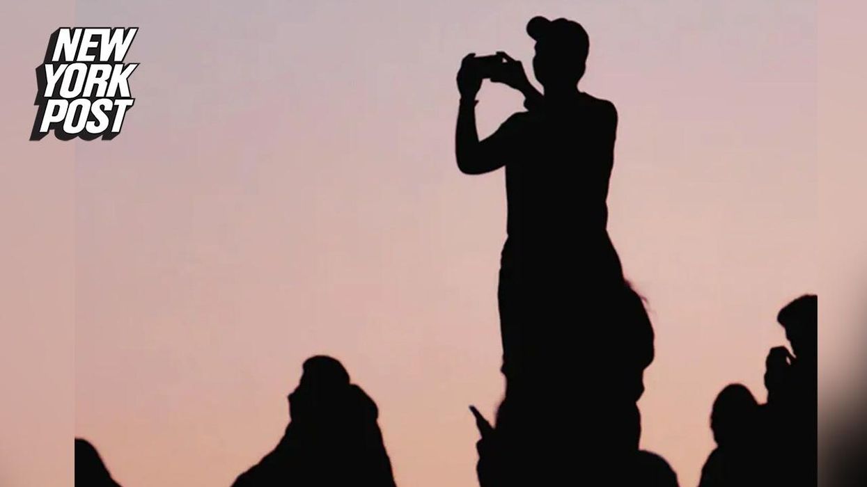 Optical illusion of man taking a sunset photo has people confused about what direction he is facing