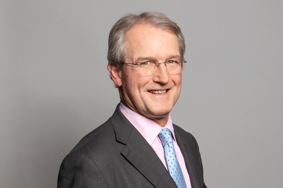 Owen Paterson, a white man with glasses, short grey hair and a grey suit.