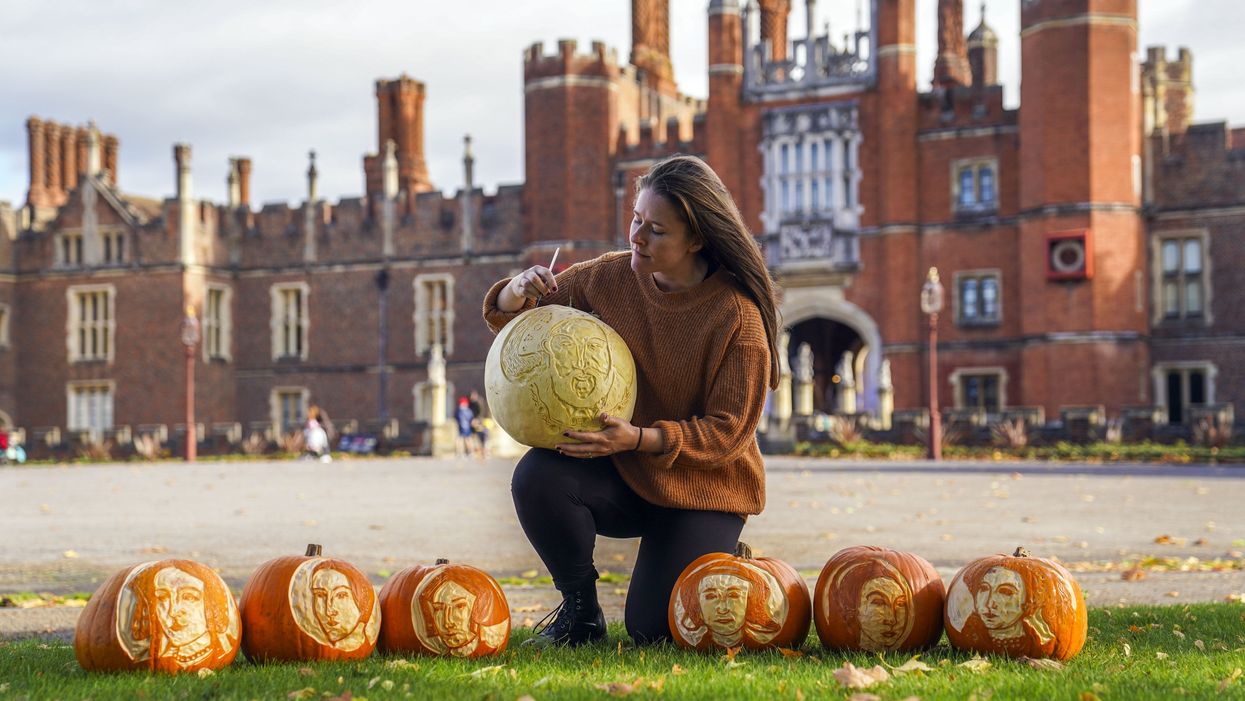 Palace gardener Justine Howlett adds the finishing touches to a pumpkin (Steve Parsons/PA)