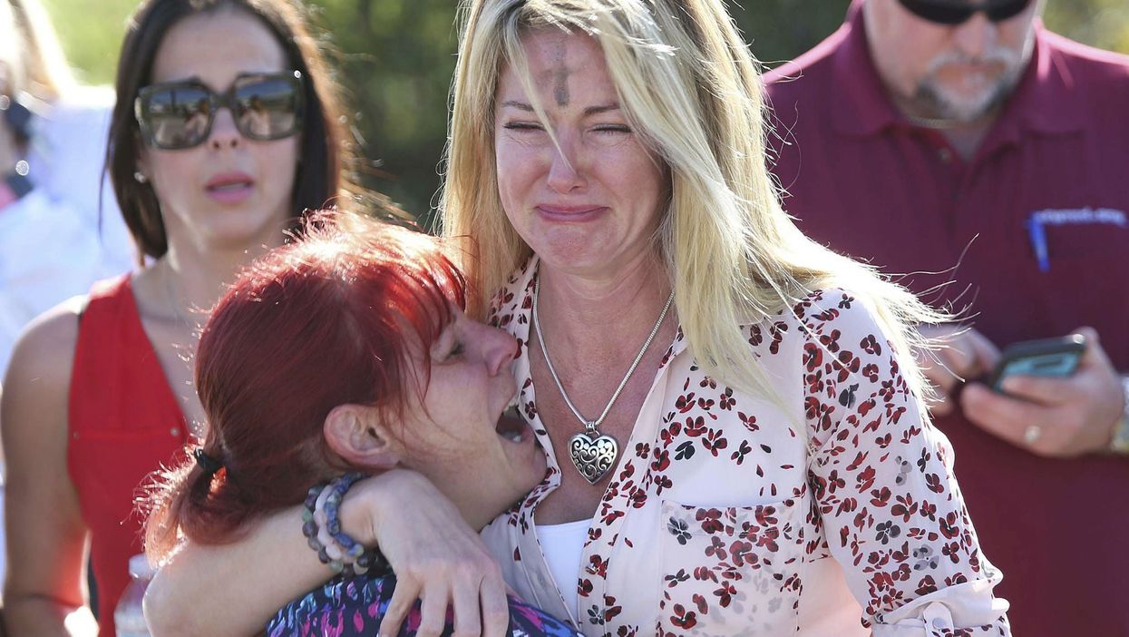 Parents wait for news after a shooting at Marjory Stoneman Douglas High School in Parkland, Florida