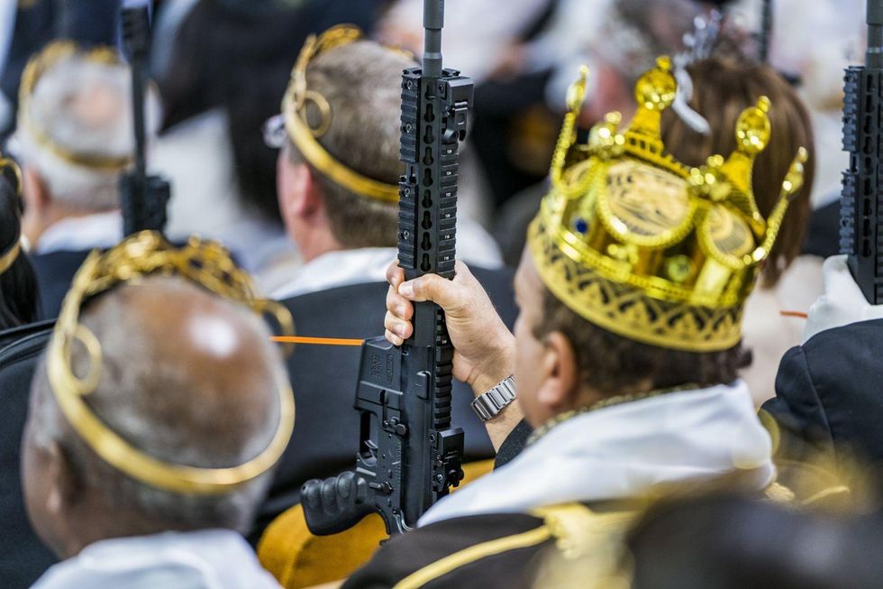 Parishioners with the Sanctuary Church hold onto their AR-15s
