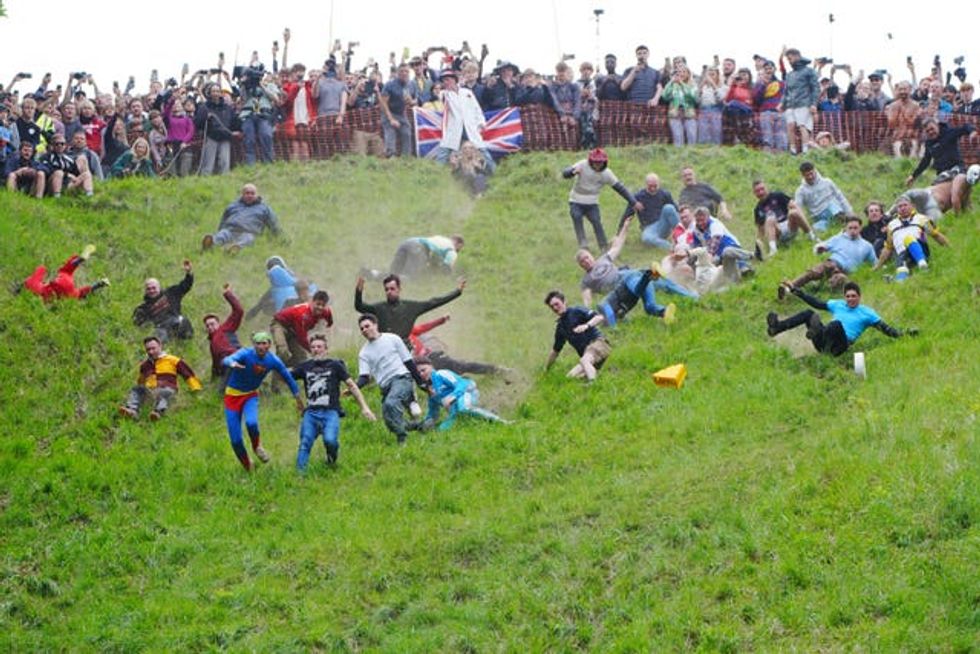Participants take part in the annual cheese rolling at Cooper\u2019s Hill in Brockworth, Gloucestershire