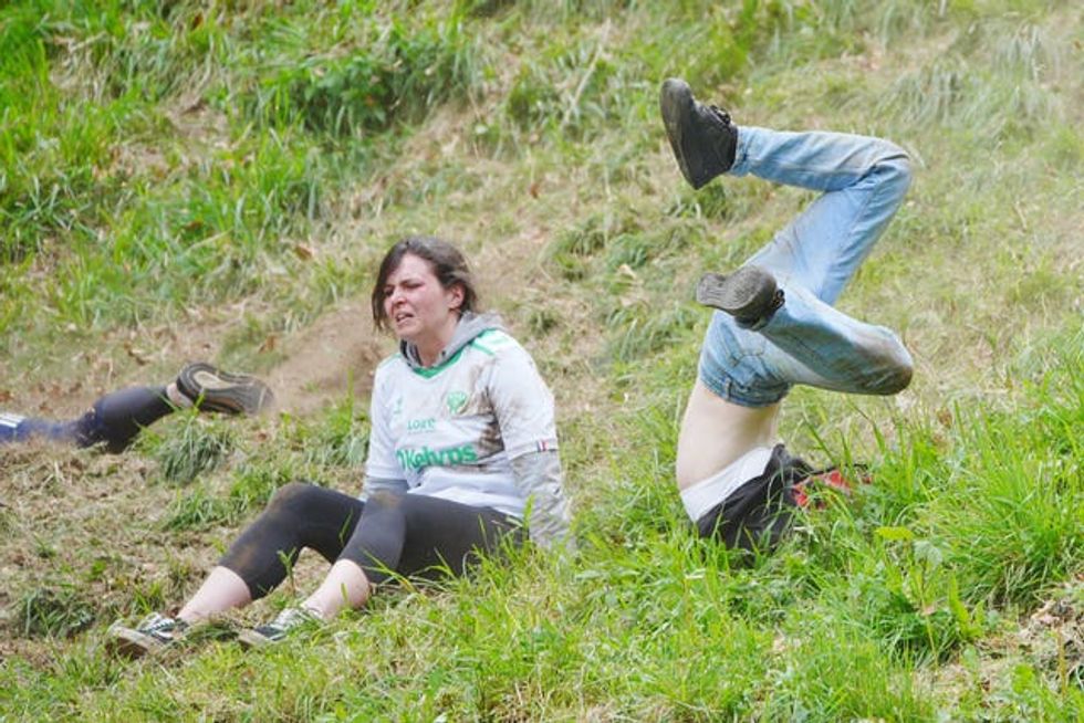 Participants take part in the women\u2019s race during annual cheese rolling at Cooper\u2019s Hill in Brockworth, Gloucestershire