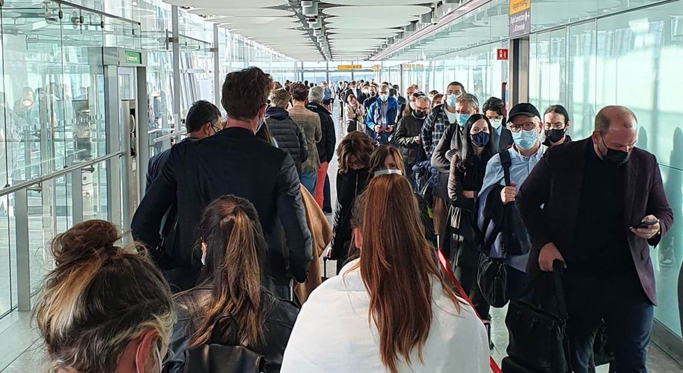 Passengers queue for the arrival hall at London Heathrow Airport (Clive Marshall/PA)