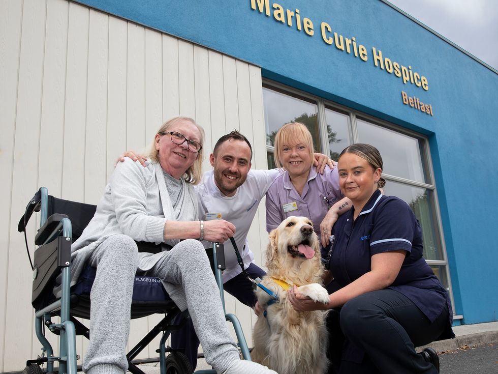 Patricia Hutchinson with, nurse Andrew Hunter, healthcare assistant Rachel McGlone and clinical nurse specialist Laura Cudden with volunteer therapy dog Sandi. (Phil Smyth/Marie Curie handout).