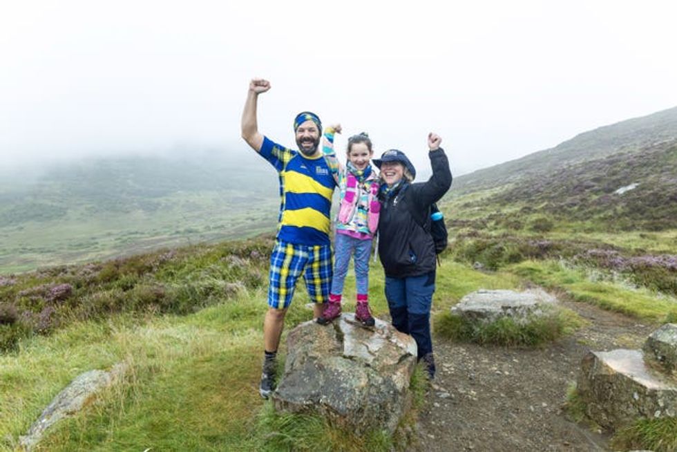 Paul Choat with his daughter Skye and Nicola Roseman chief executive of My Name5 Doddie Foundation on Schiehallion