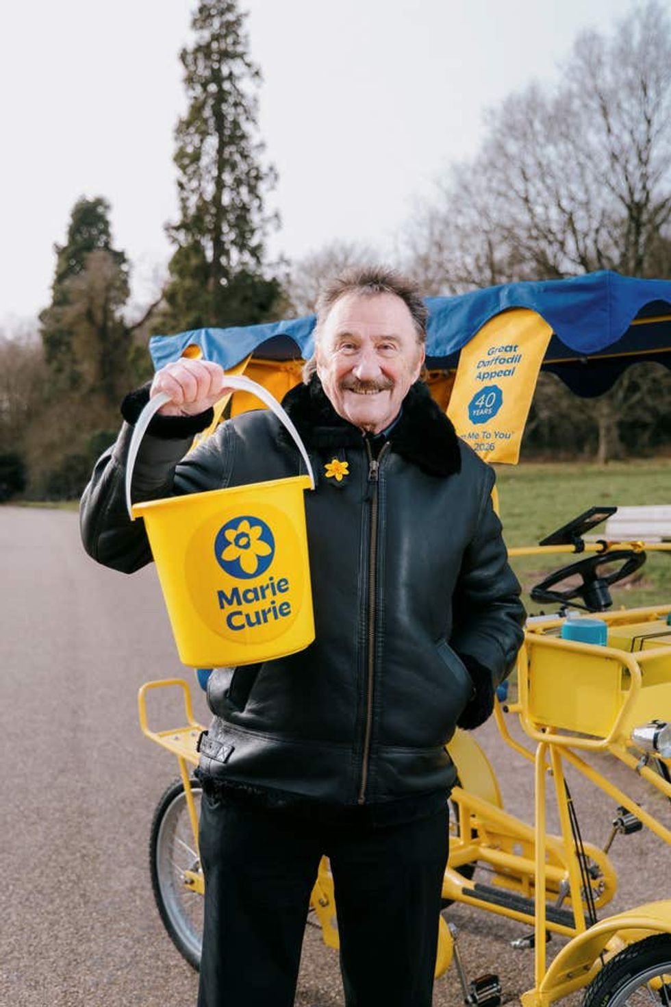 Paul Elliott holds a Marie Curie donation bucket