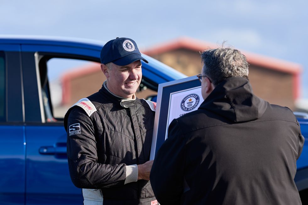 Paul Swift achieves the Guinness World Record for 'The tightest gap driven through on two wheels in a pick up truck (88cm)' in celebration of Guinness World Records Day 2023