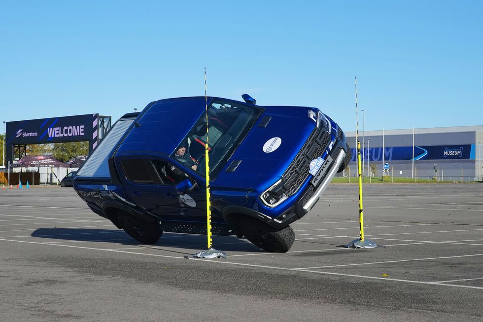 Stunt driver breaks record driving pickup truck on two wheels through tight gap