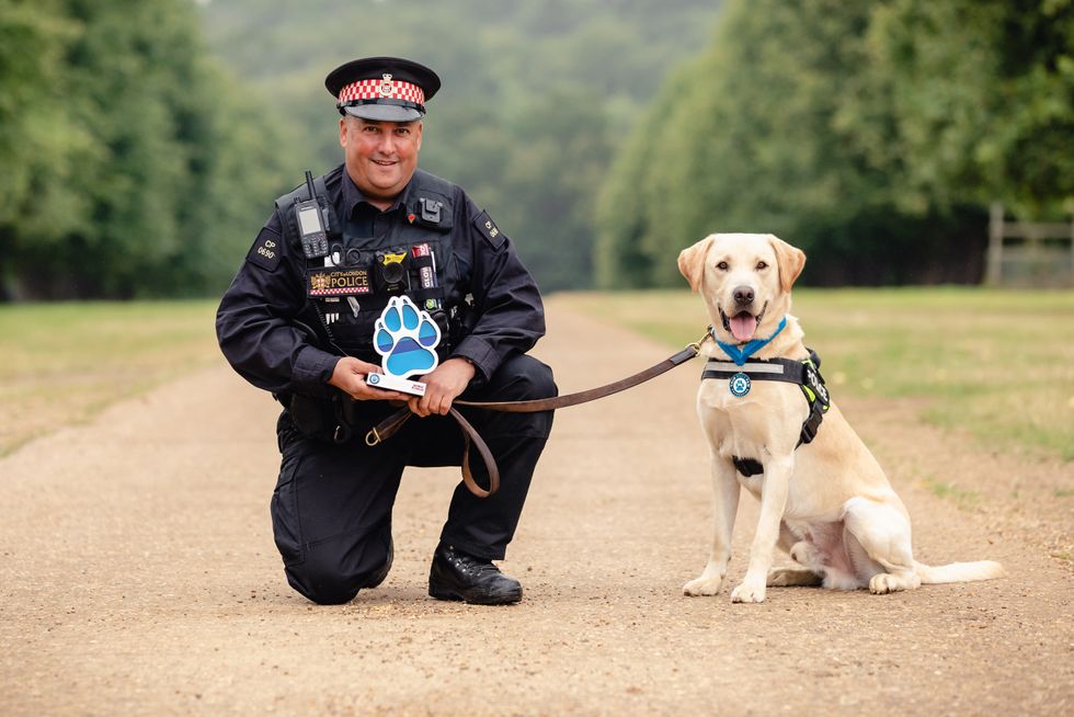 Pc Colin Nash and two-year-old labrador Elvis (Penny Bird/Thin Blue Paw Awards/PA)