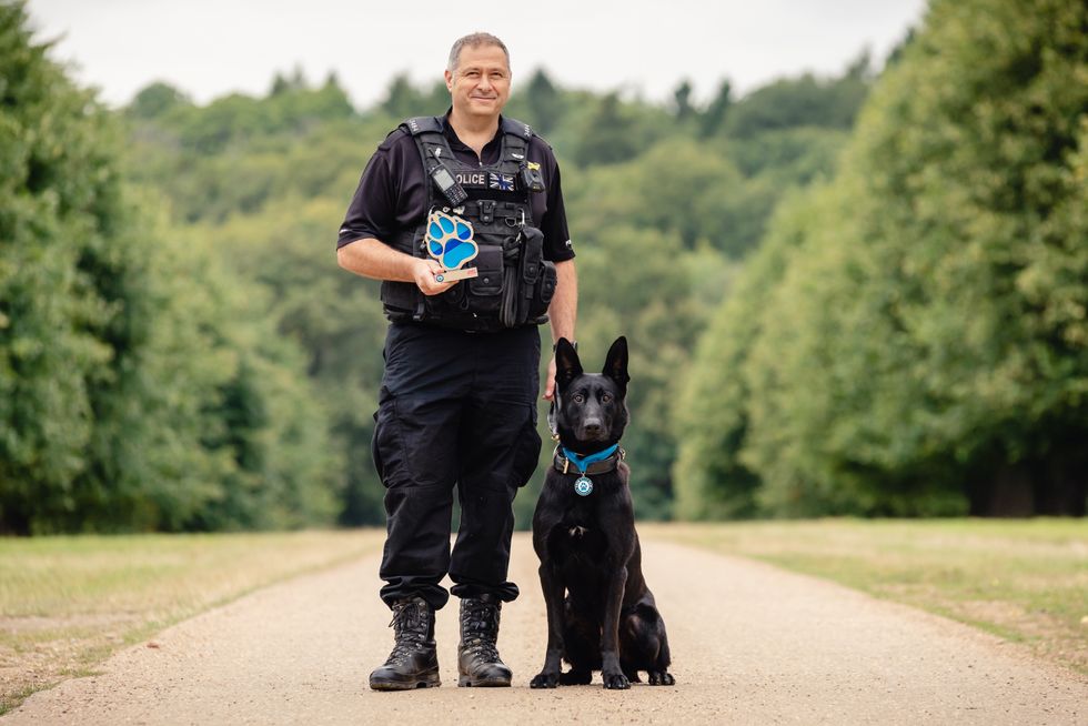 Pc Paul Hopley and West Midlands Police dog Stark (Penny Bird/Thin Blue Paw Awards/PA)