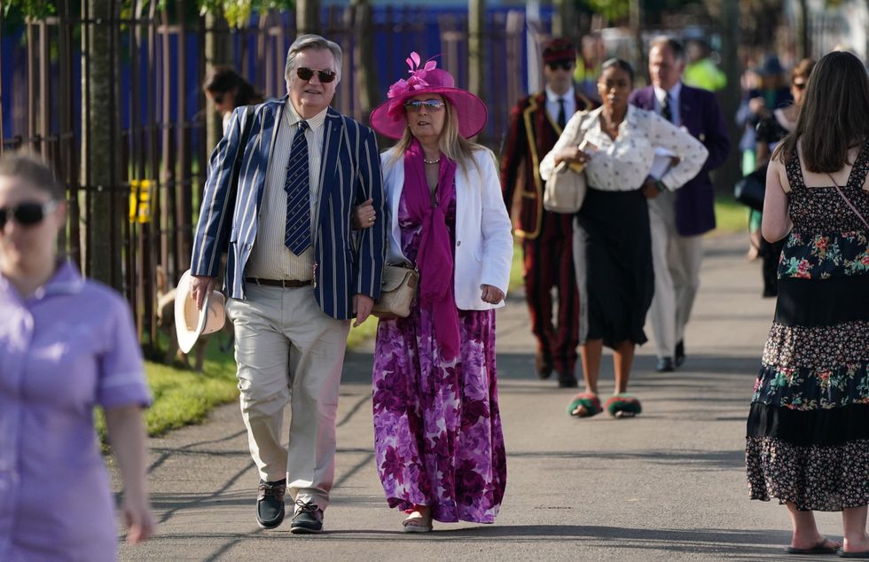People arrive on the opening day of the 2021 Henley Royal Regatta alongside the river Thames. (Andrew Matthews/PA)