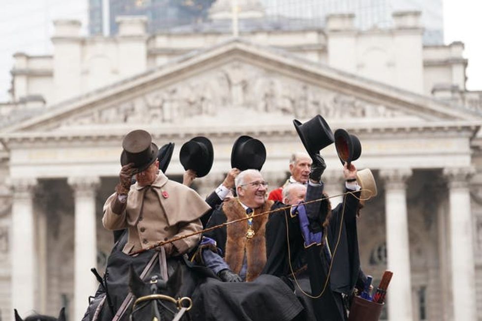 People dressed in period costumes tip their hats during the Lord Mayor\u2019s Show 2024
