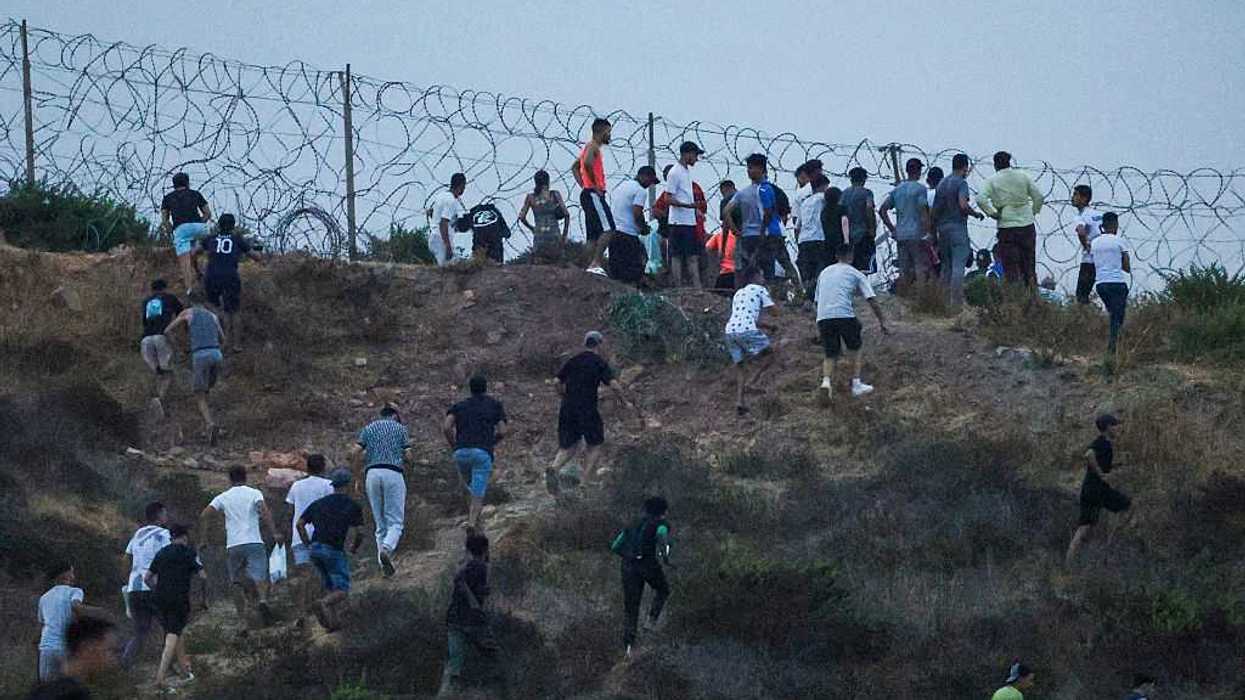 People gather on a hilltop near Bab Sebta on the Morocco-Spain border, near Spain's enclave of Ceuta and the Moroccan town of Fnideq.