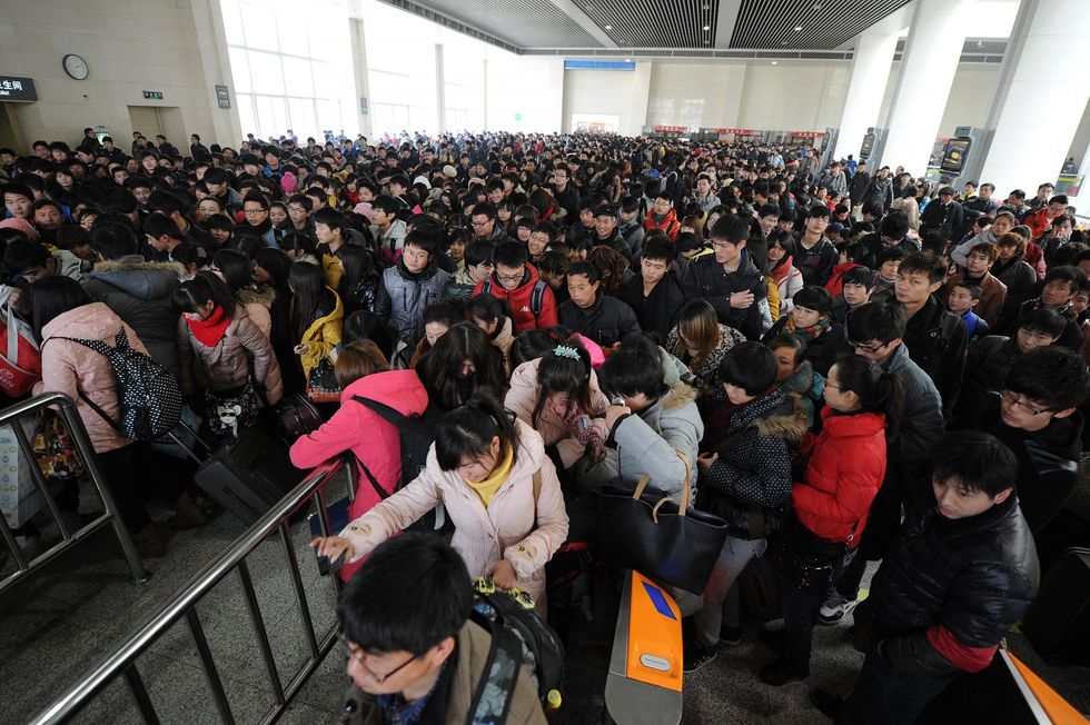 People headed to their trains after waiting at a railway station in Hefei, in central China's Anhui province.