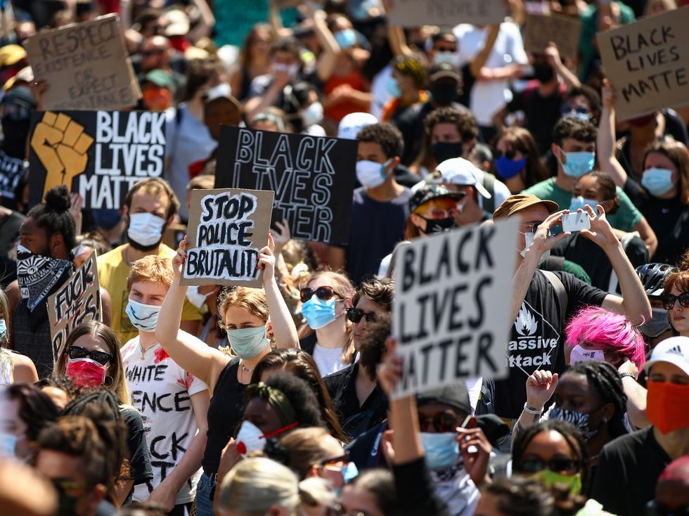 <p>People hold placards as they join a spontaneous Black Lives Matter march at Trafalgar Square to protest the death of George Floyd in Minneapolis and in support of the demonstrations in North America on May 31, 2020 in London.</p>