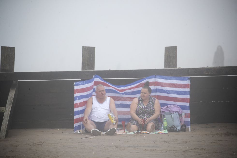 People on Edinburgh\u2019s Portobello Beach surrounded by mist
