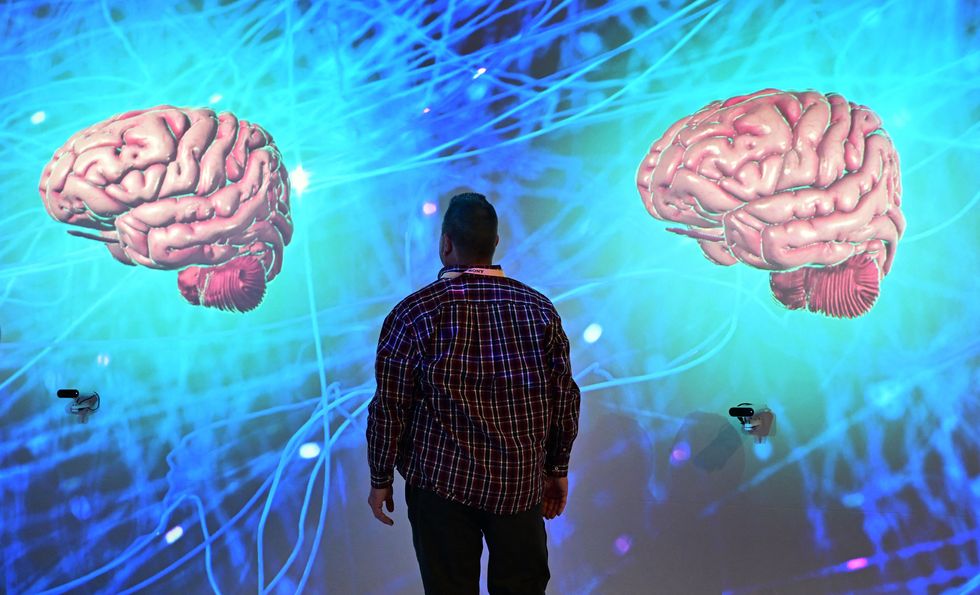People participate in an interactive experience from Dassault Systemes showcasing their Living Heart and Living Brain project at the Consumer Electronics Show (CES) in Las Vegas, Nevada on January 11, 2024.
