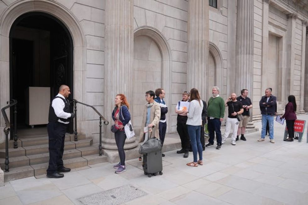 People queue outside the Bank of England, London, on the day the new banknotes featuring the King\u2019s portrait are being issued