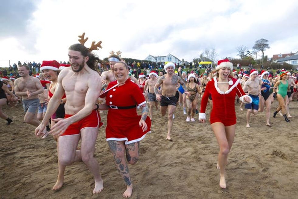 People running into the water at Helen\u2019s Bay